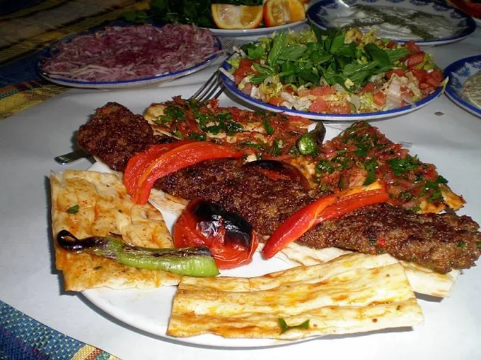 Adana kebab plate with mixed salad and warm bread